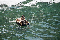 lone fisherman in small boat