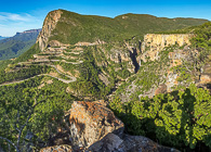 road hairpins climbing green escarpment