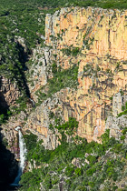 waterfall on top of gorge & colorful cliff