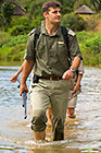 ranger, guests & tracker crossing river barefoot