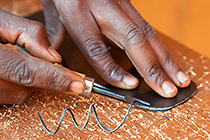 man making leather shoe
