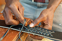 man making secret plate leather belt
