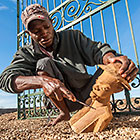 Malawi artist polishing wooden sculpture