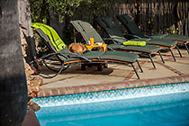 long chairs near swimming pool