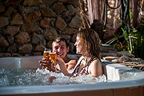 young couple drinking champagne in jacuzzi